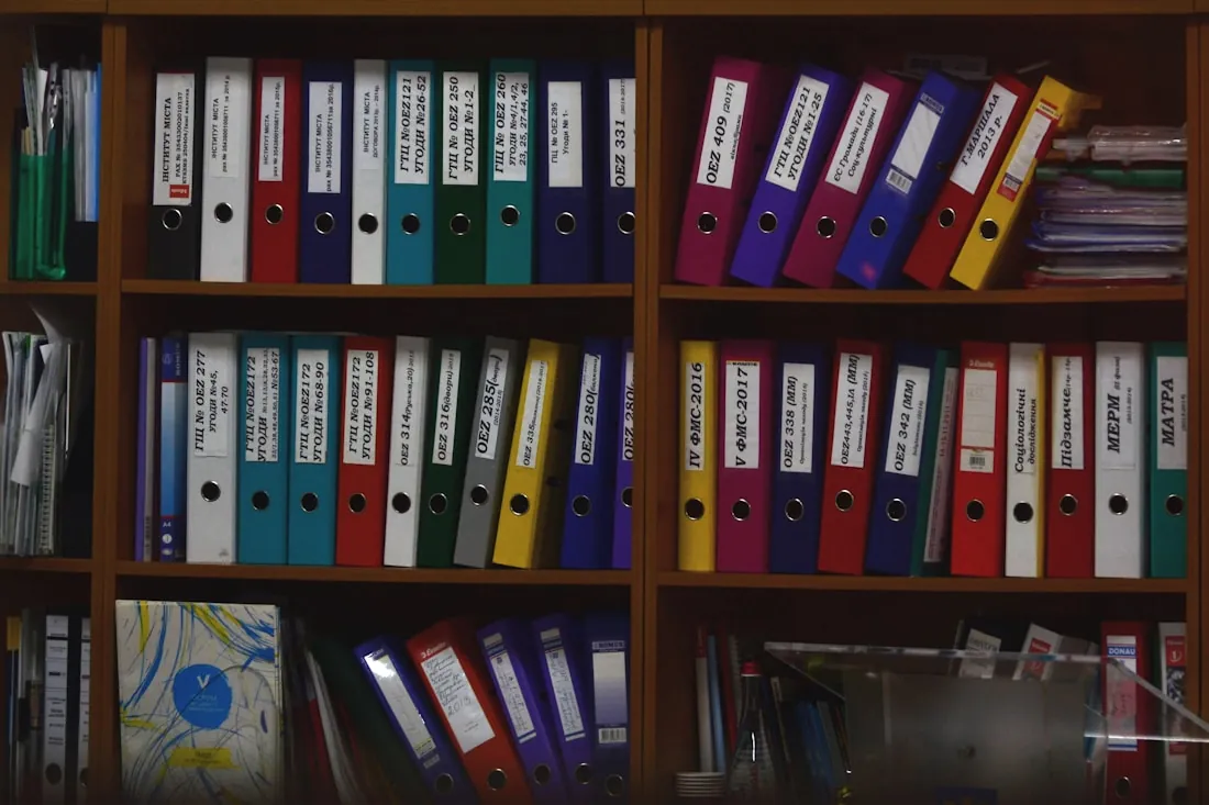 Shelves of labelled ring binders holding client files
