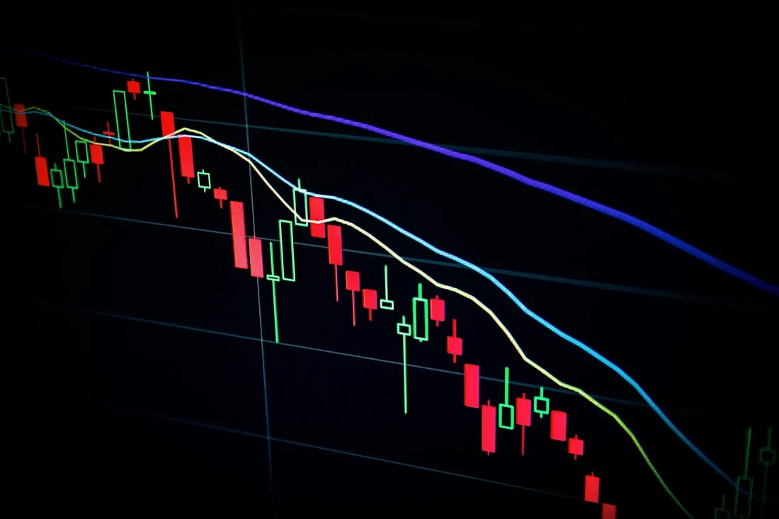 Candlestick trading chart on a dark screen