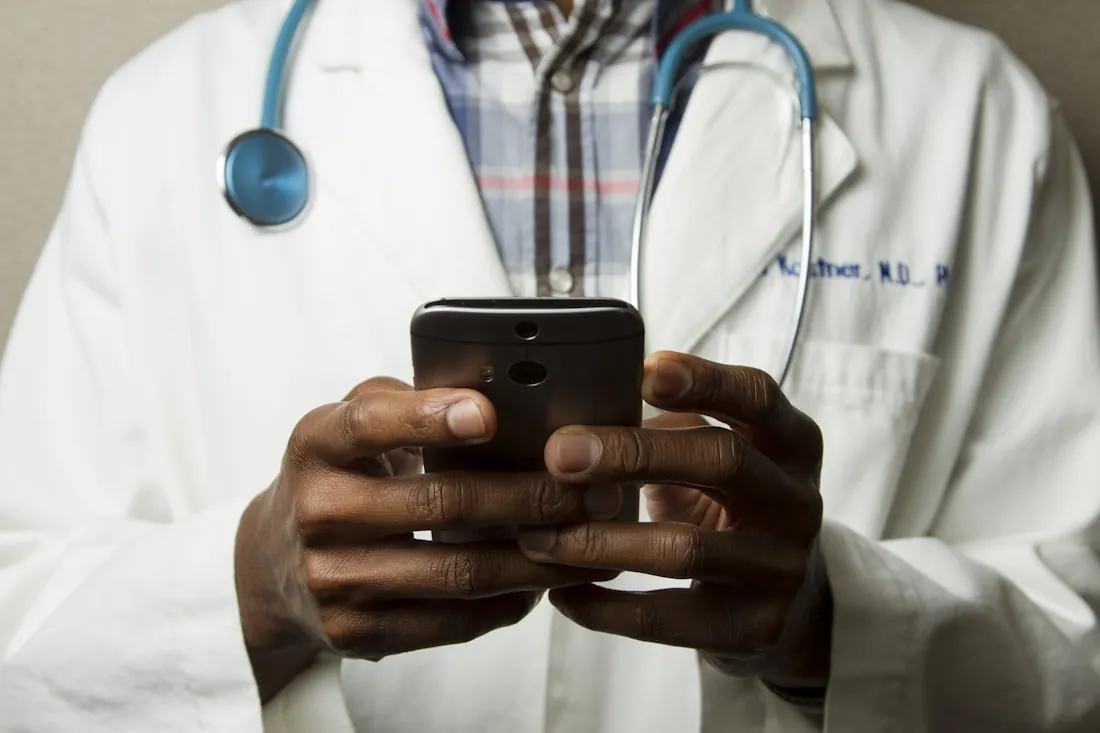 A clinician reviewing patient information on a handheld device