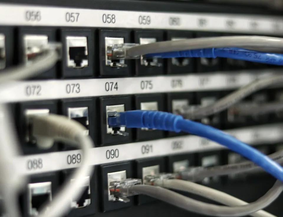 Network patch panel with cables connecting numbered ports