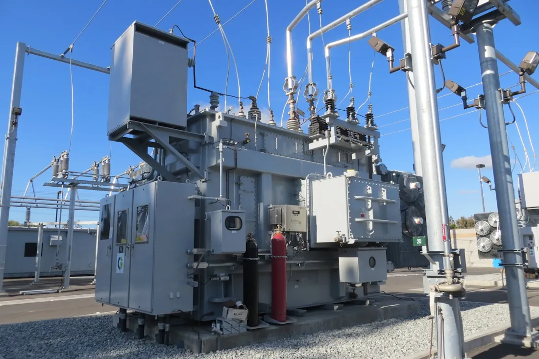 A high voltage transformer inside an electrical substation