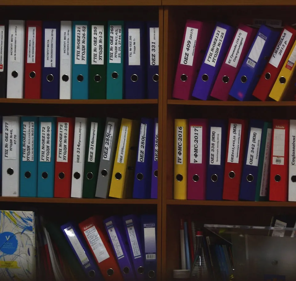 Shelves of labelled ring binders holding client files