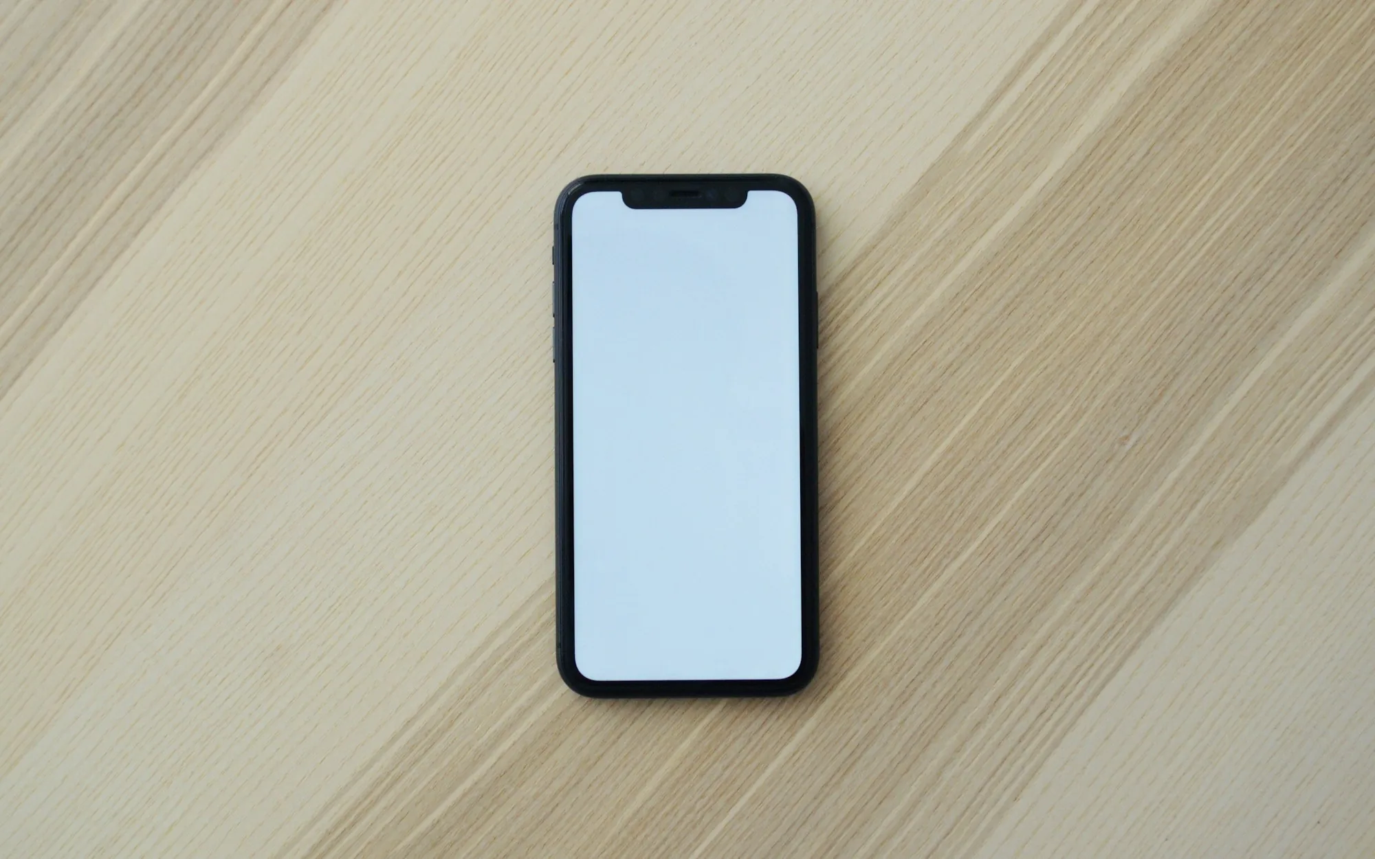 An unbranded handset on a plain surface