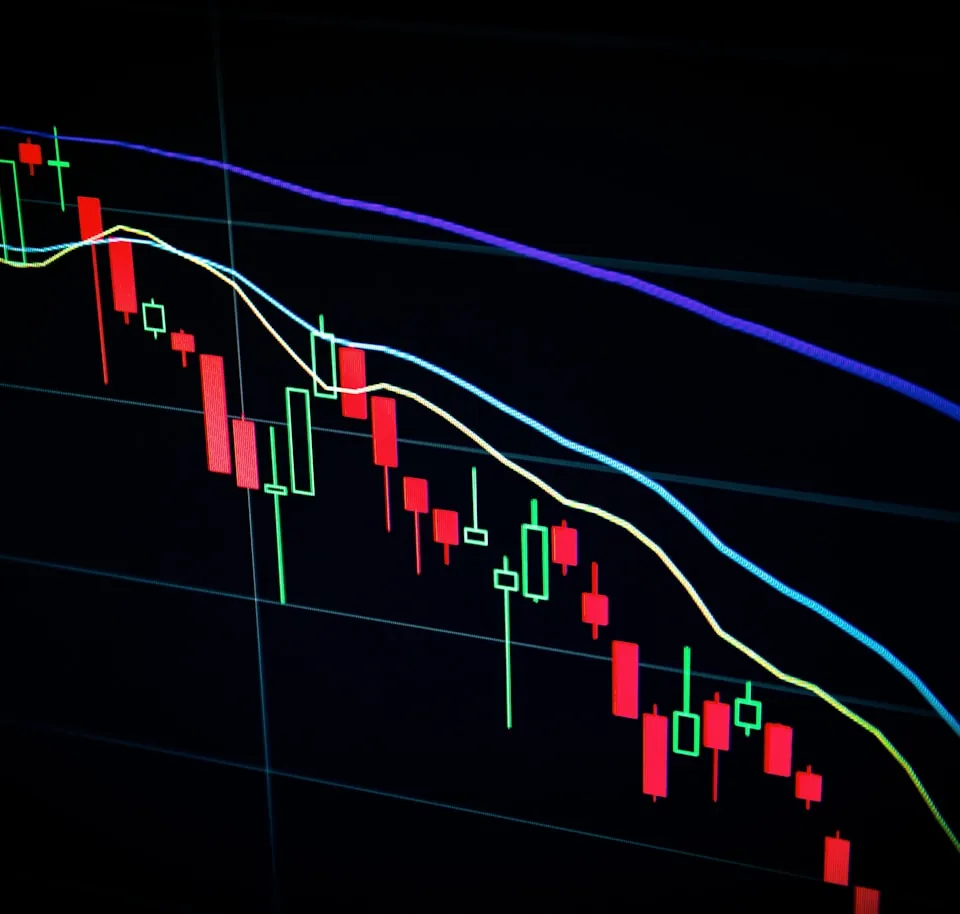 Candlestick trading chart on a dark screen
