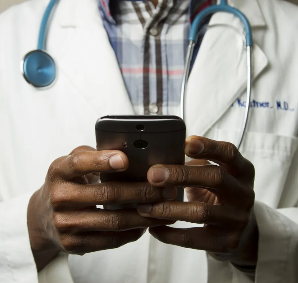 A clinician reviewing patient information on a handheld device
